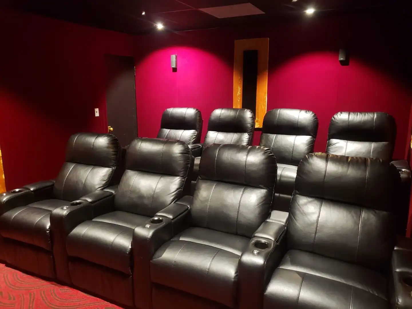 Luxurious small home theater with adjustable super comfortable chairs and state-of-the-art audio-visual equipment.